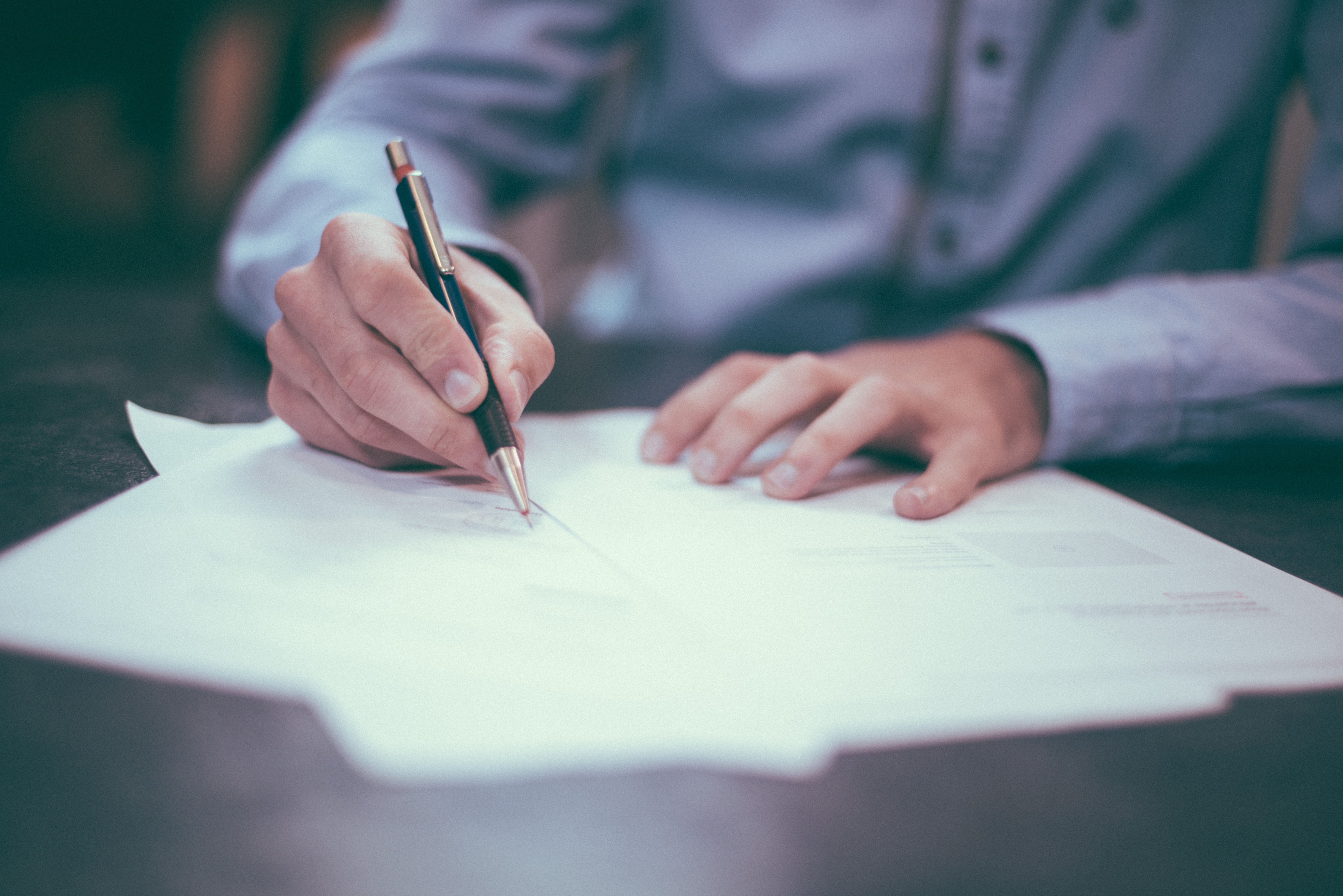 Man or woman doing paperwork - image of hands and papers