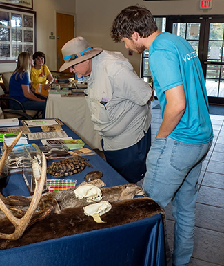 volunteer at outreach table