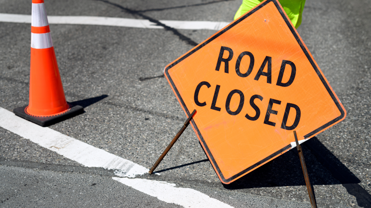 Orange road closure sign